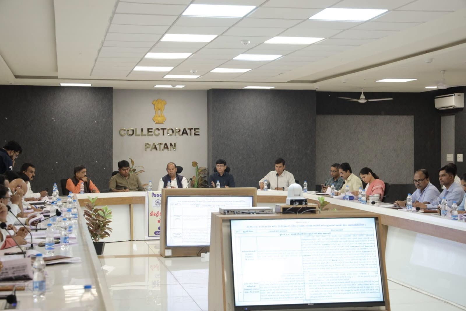 A district review meeting in progress with officials and public representatives