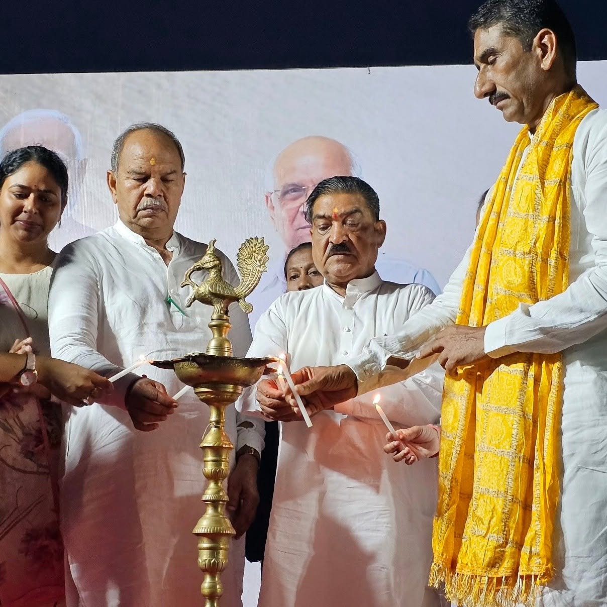 Bharatsinhji Dabhi lighting the ceremonial lamp at a public programme